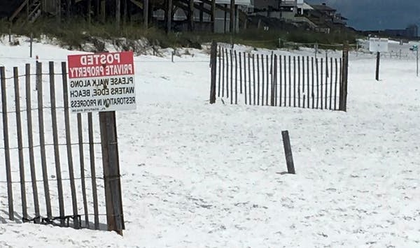 A sign marks the demarcation between public beach and private property in Santa Rosa Beach, Florida. AP Photo/Brendan Farrington