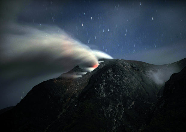 Thick smoke and ash spew from the summit of Mount Sinabung, as seen from Tanah Karo in Sumatra