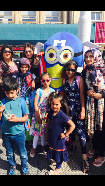 Women and children pictured posing with a Minion.