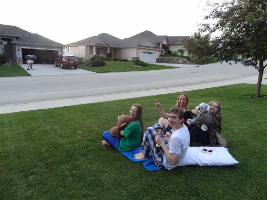 family on lawn blanket waiting