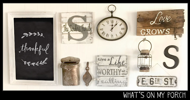 gallery wall in rectangle shape with chalkboard, signs, monogram, clock, lantern