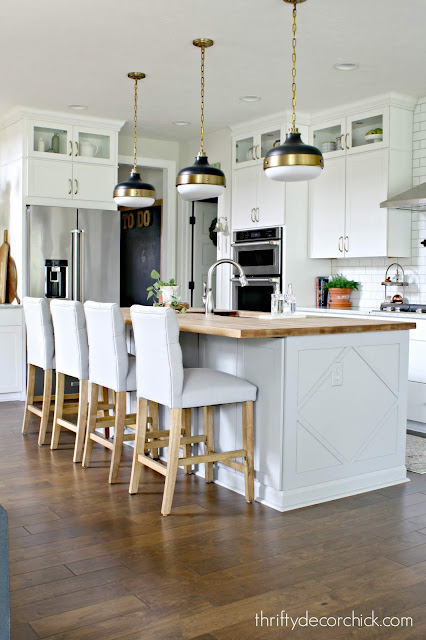 Light gray island white cabinets kitchen 