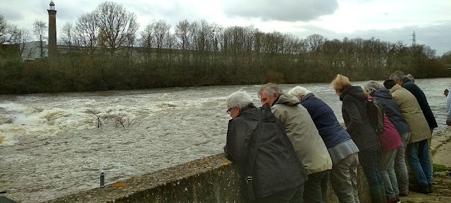 Walkers contemplating the fish ladder on the Creuse River at Descartes.  Indre et Loire, France. Photographed by Susan Walter. Tour the Loire Valley with a classic car and a private guide.