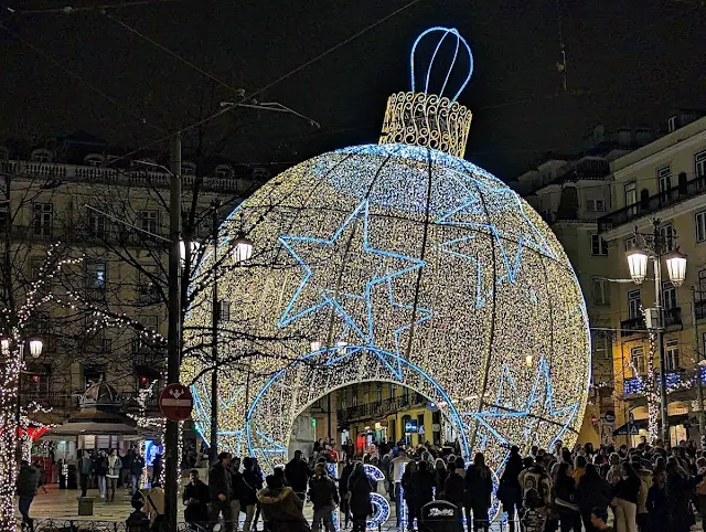 Giant Christmas decoration lit up at night on Praça Luís de Camões in Lisbon Portugal