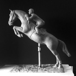 Horse and rider jumping horse bronze statue in progress.