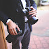 Business man in a suit holding a professional camera