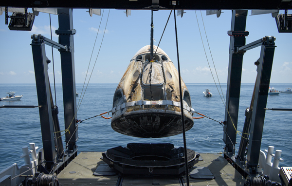 The Dragon Endeavour capsule, with NASA astronauts Doug Hurley and Bob Behnken onboard, is lowered onto the deck of SpaceX's 'GO Navigator' recovery ship in the Gulf of Mexico...on August 2, 2020.