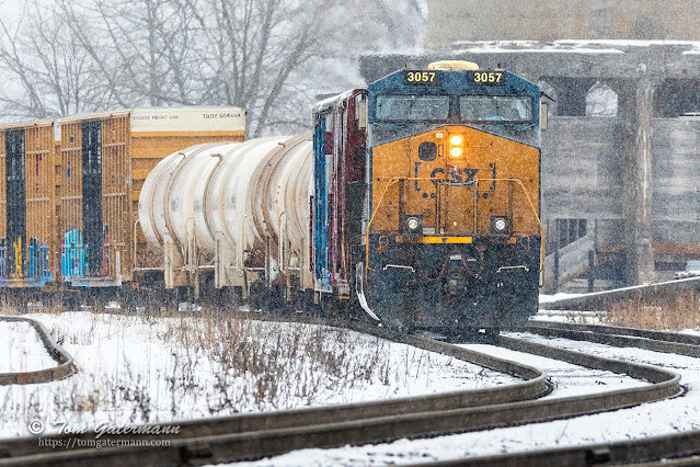 With snow falling, M364-25 is stopped on Track 1 at CP 286 waiting for I009-24 to clear ahead of it.