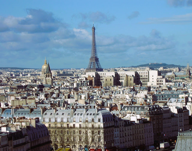 View of Eiffel tower over rooftops of Paris