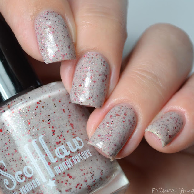 beige nail polish with red glitter