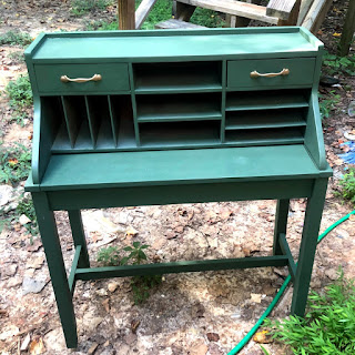 The secretary desk painted with the green color, brass painted handles attached