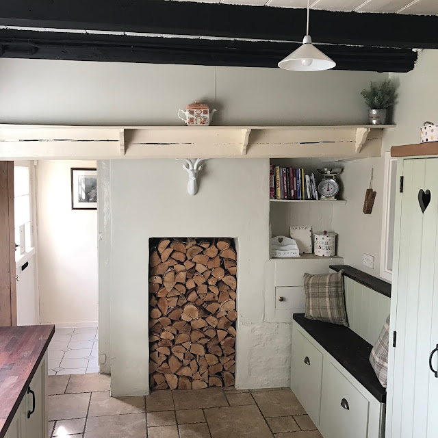 cottage kitchen inspiration featuring log filled fireplace and Emma Bridgewater collection 