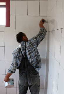 Bekir grouting the bathroom