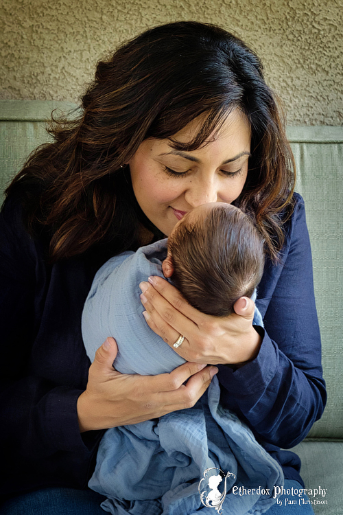 Professional portrait of a newborn baby and family outside