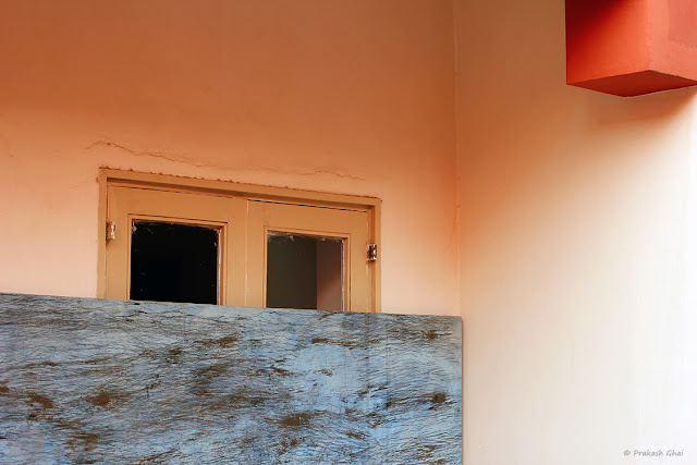 A Minimal Art Photograph of a Window Behind a Rectangular Plyboard