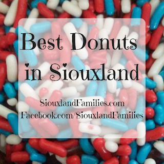 in background, red white and blue sprinkles on a donut. in foreground, "best donuts in siouxland"