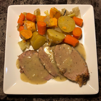 Herb crusted roast beef with carrots, celery, onions, sweet potatoes and regular potatoes, with a fresh gravy