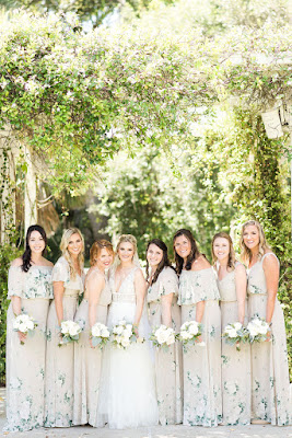 bridesmaids in flower dresses with bride