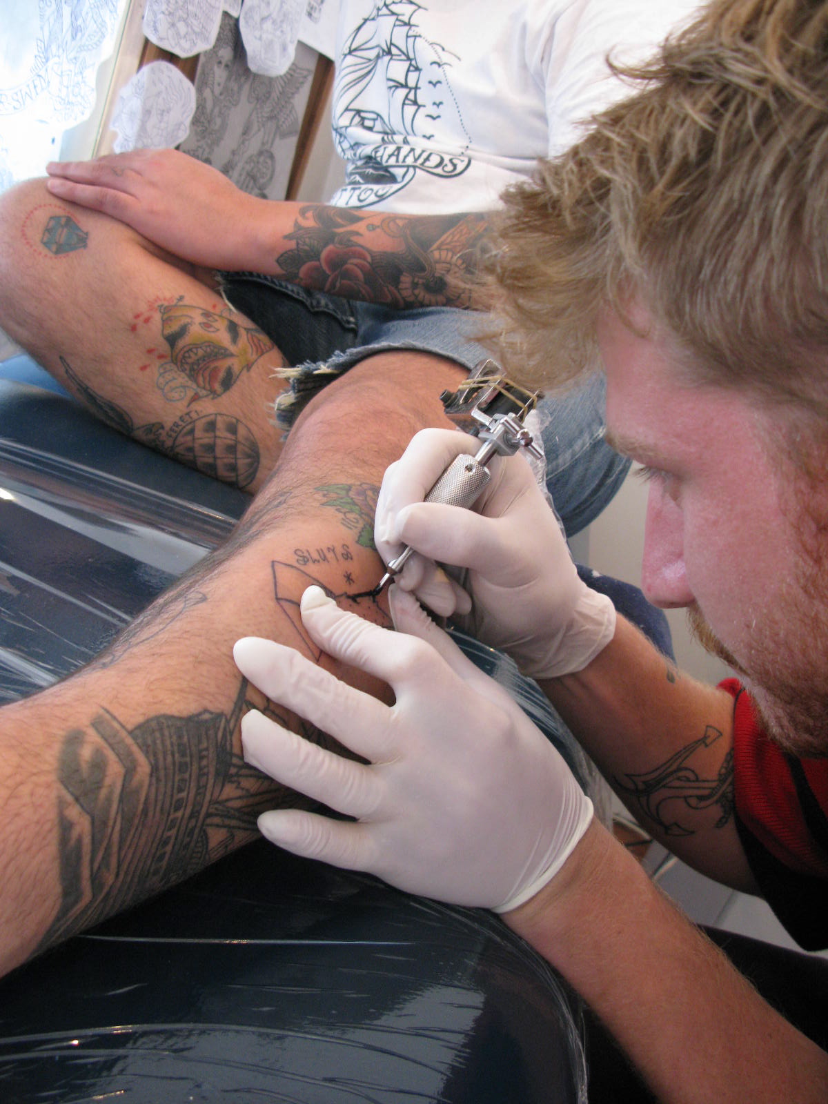 Sam Montgomery tattooing a