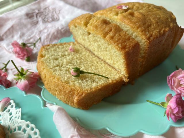 Slices of small pound cake made with 2 eggs, decorated with pink roses on a blue plate with a white lace doily