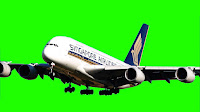 A jumbo jet with text reading Singapore airlines flys towards camera with a  green background.