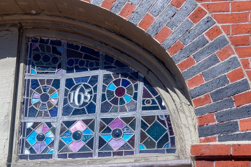 Portland, Maine USA March 2019 photo by Corey Templeton. One of the stained glass windows above 165-167 Congress Street, on Munjoy Hill. This building is known as the Francis W. Cunningham house.