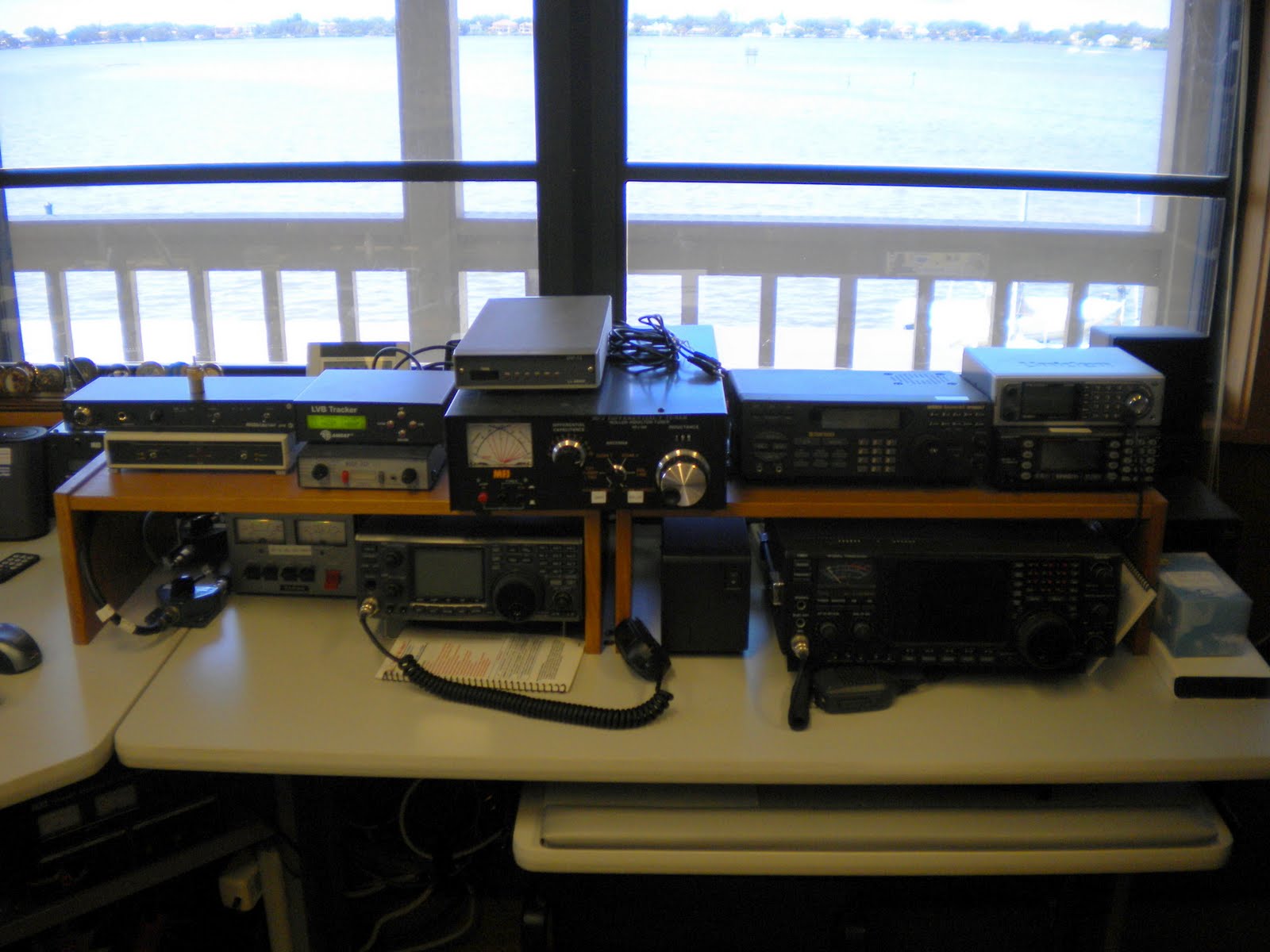 Another large desk is packed with lots of ham radio gear.