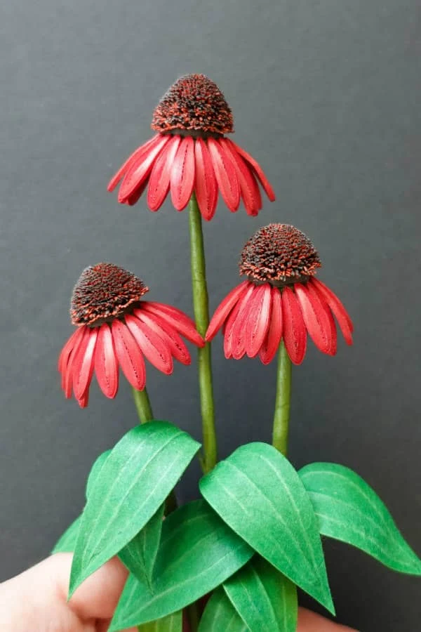 trio of realistic quilled red flowers with fringed centers