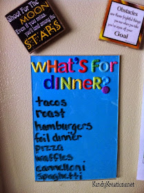 Keep track of What's for Dinner with this easy and fun Menu Board DIY.  With just a few simple dollar store items, you will be organized and on budget without the dreaded "What's for dinner" every night.