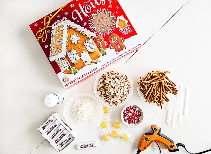 gingerbread house kit, gum, candies, almonds, icing, glue gun