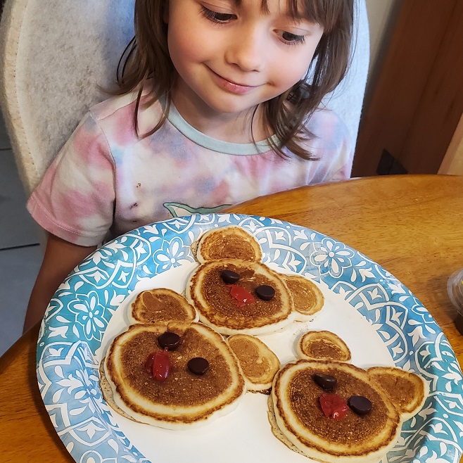 talia making mickey mouse pancakes with grandma