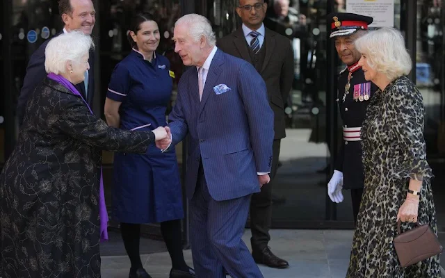 Queen Camilla wore a floaty leopard print dress and Van Cleef Arpels green and gold bracelet