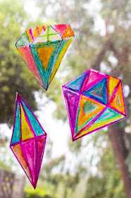 "Painting" with oil pastels to create beautiful "crystal" sun catchers with kids