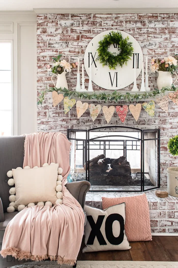jumbo paper heart garland, painted brick, fireplace mantel, pink accents