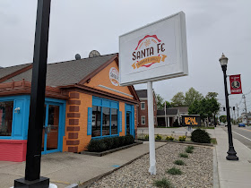 The new Santa Fe Grill has their signs up on their brightly colored building.
