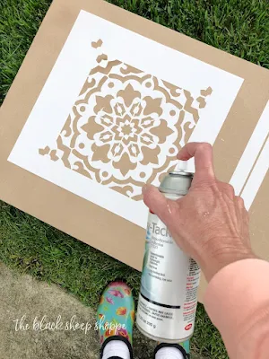 Low tack spray adhesive on stencil.