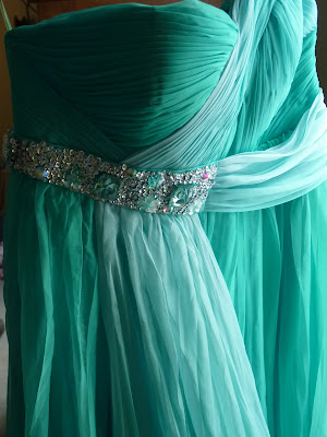 A Grecian style gown in aqua blue with light blue overlay