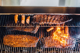 Our Bull Grill from Goodwood Hardware loaded up with meats at Tin Roof Brewing