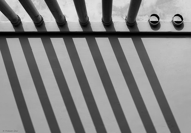 A Looking Up Black and White Minimalist "Photograph of Two Missing Pipes from a Pipe Arrangement. 