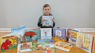 Garett shows off the kindness books for his Kindness Corner.