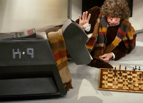 Tom Baker as The Doctor plays chess with K-9 in the BBC show 'Doctor Who'