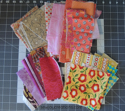 warm colour fabrics liberated churn dash quilt