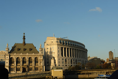 Two historic buildings next to the Thames in London