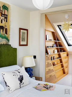 Beata Heuman bedroom with built-in wood cabinets in closet