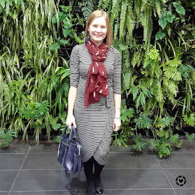 awayfromtheblue Instagram | work outfit tulip hem jersey wrap dress burgundy feather print scarf regan bag