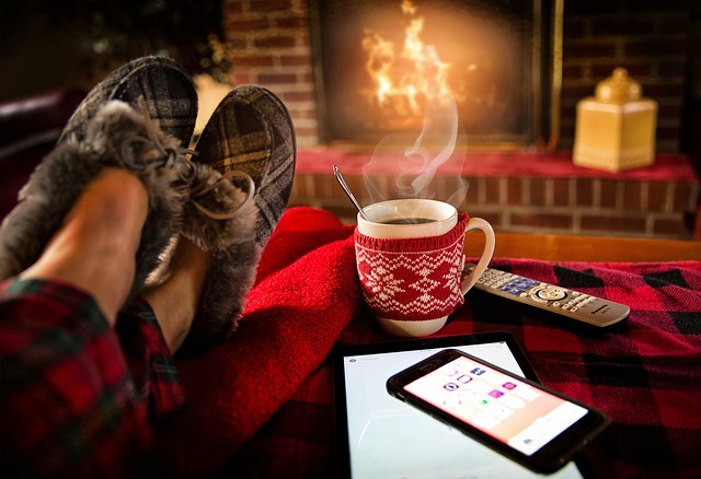 Relaxing in front of a fireplace with a cup of hot cocoa