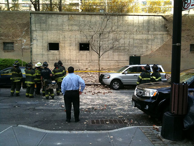 The wall is outside a parking garage, which is built under a courtyard/lawn 