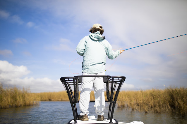 Brian Flechsig fly casting on a boat while discussing fly rod action