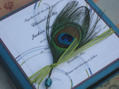 Tuck a peacock feather in your invites to add rich color