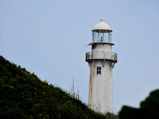 Visão do Farol a partir da praia do farol em um dia semi-ensolarado